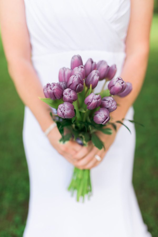 Bride holding purple tulips